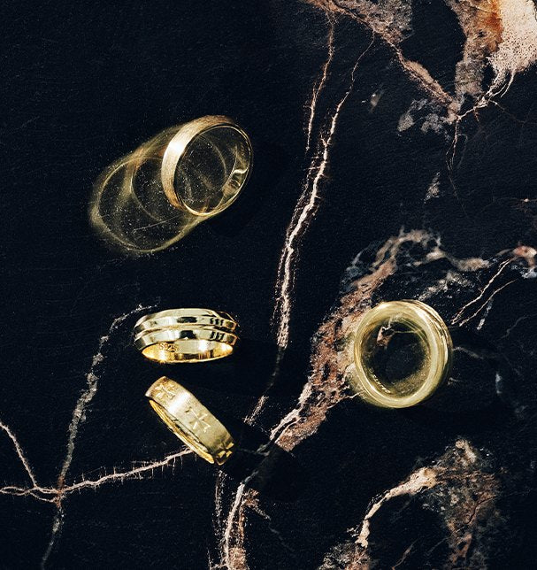 Men's rings on dark marble