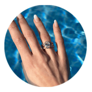 Hand with a travel ring by the pool
