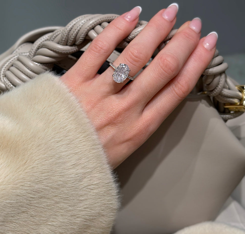 Hand wearing an oval solitaire divorce ring
