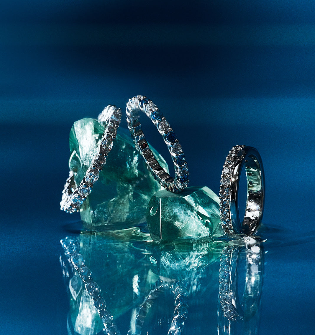 Eternity bands displayed on blue ice