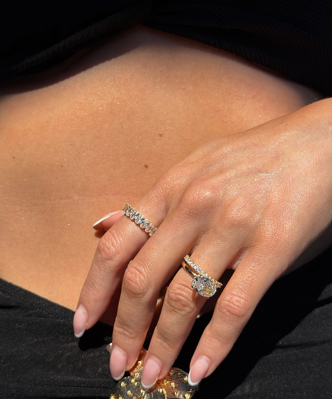 Customer wearing an eternity band and pear engagement ring