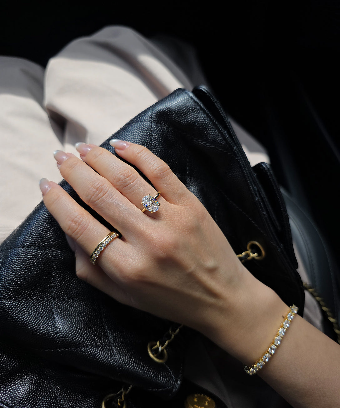 Customer ring stack styled with a black leather bag