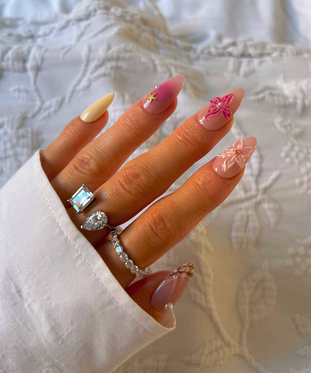 Customer wearing stacked eternity rings with french manicure