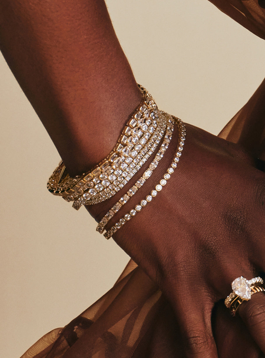 Stack of tennis bracelets and bangles