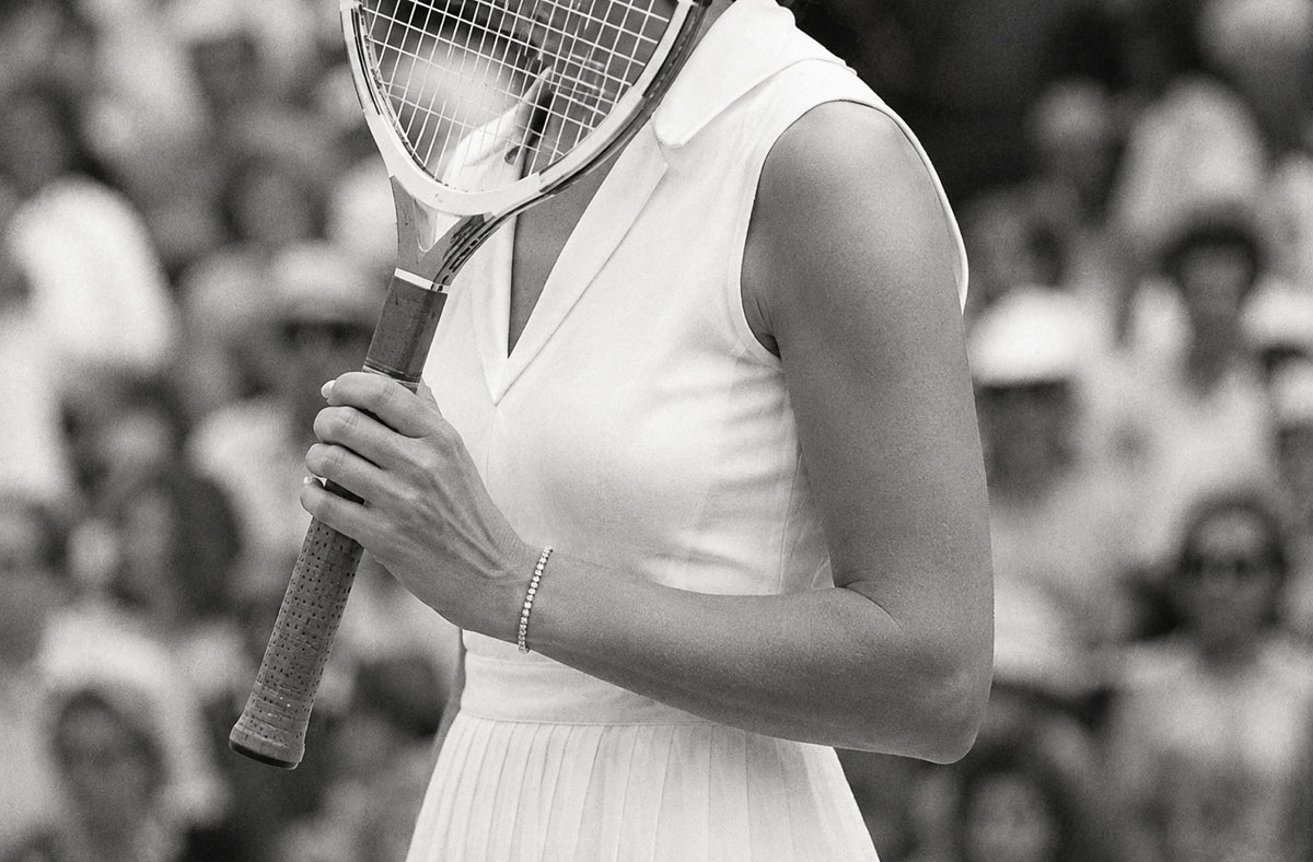 Black and white photo of a tennis player mid-match