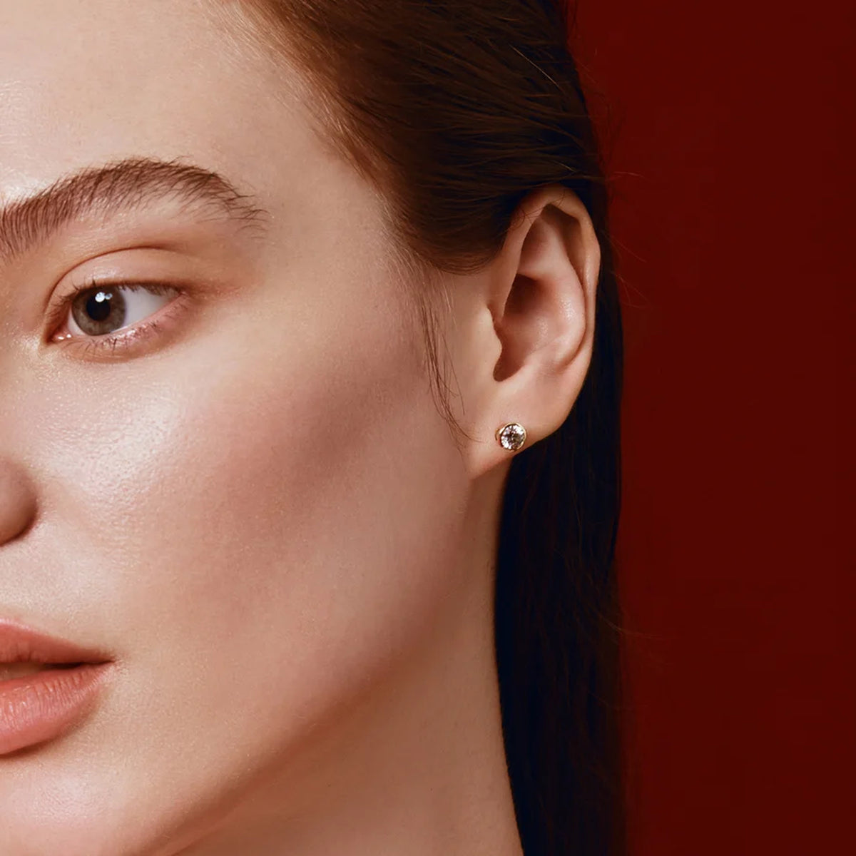 Model wearing a solitaire stud earring
