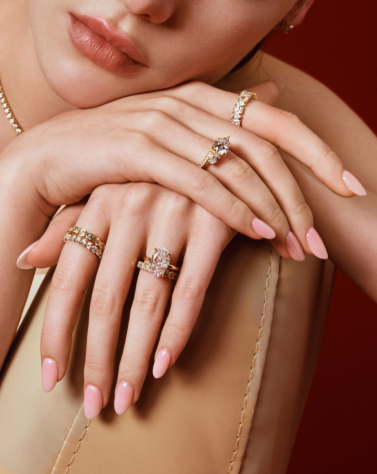 Hands wearing stacked gold rings