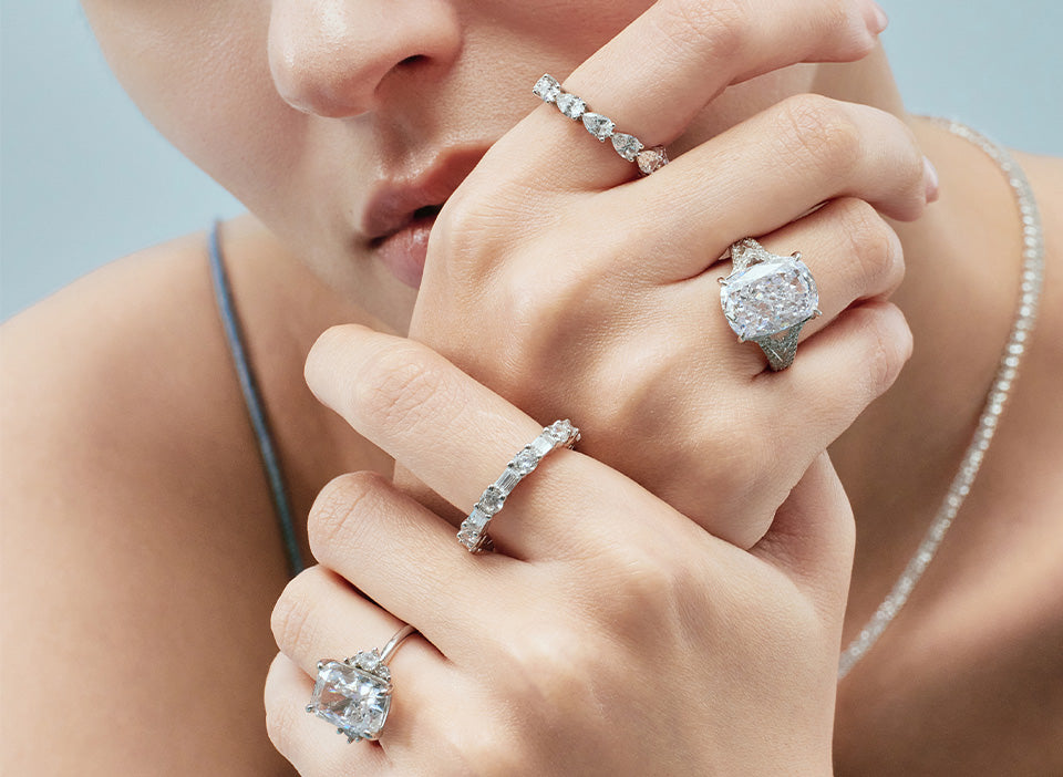Man wearing men's rings and a tennis bracelet