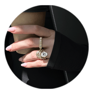 Hand with a travel ring holding a coffee cup