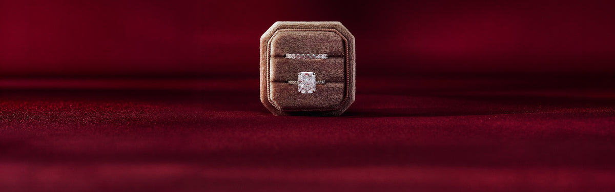 Ring box with an engagement ring on red velvet