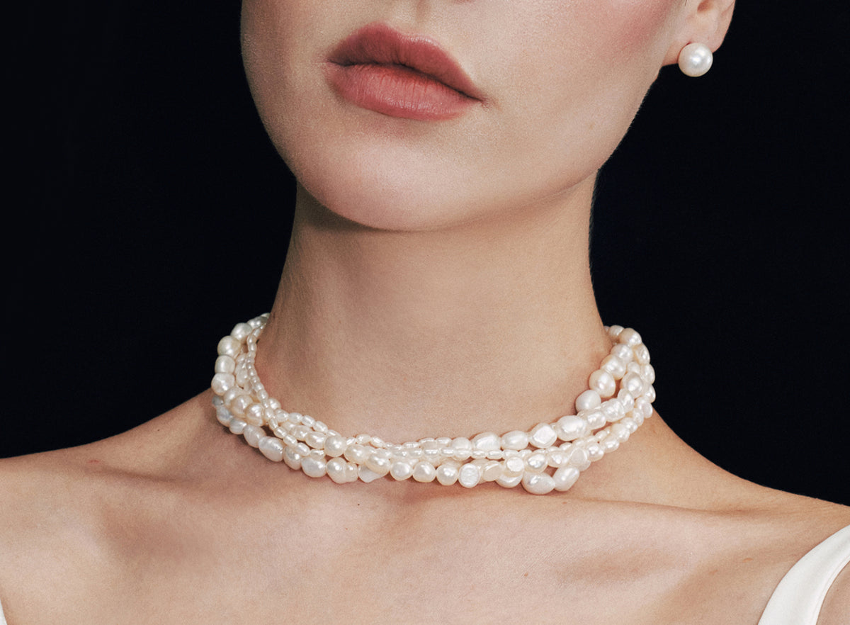Model wearing a layered freshwater pearl necklace