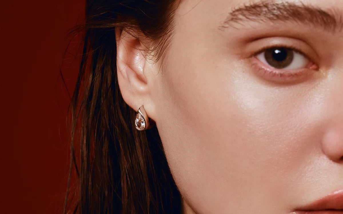 Model wearing a drop earring