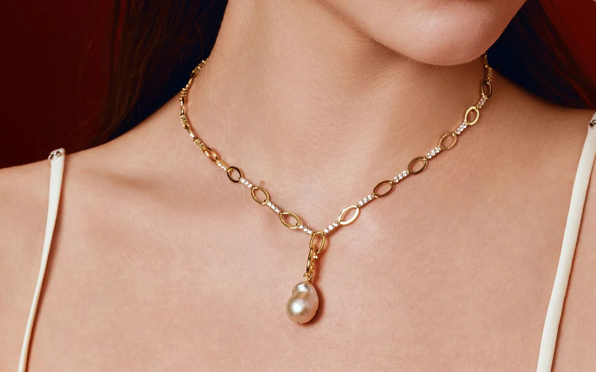 Gold chain necklace with a pearl drop pendant